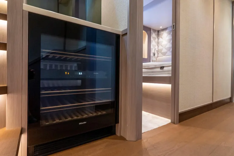 Slide: The Image of Luxurious interior of Absolute NAVETTA 70 yacht, featuring a modern wine cooler, 2026 model. - 68