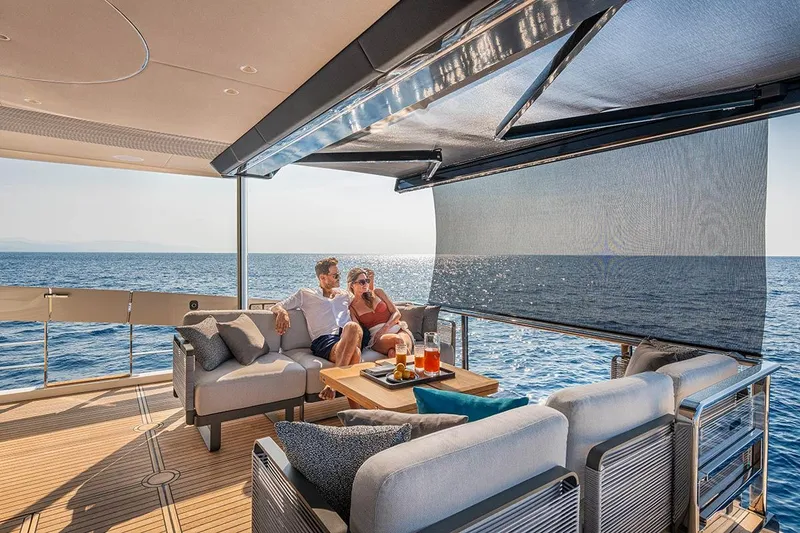 Slide: The Image of Couple relaxing on Absolute NAVETTA 70 yacht, 2026 model, enjoying ocean view. - 7