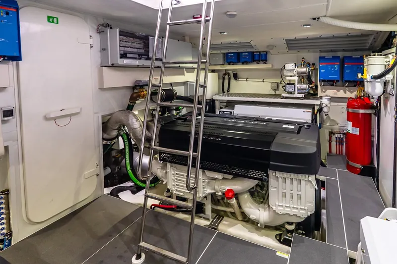 Slide: The Image of Engine room of 2026 Absolute NAVETTA 70 yacht with modern equipment and ladder access. - 83