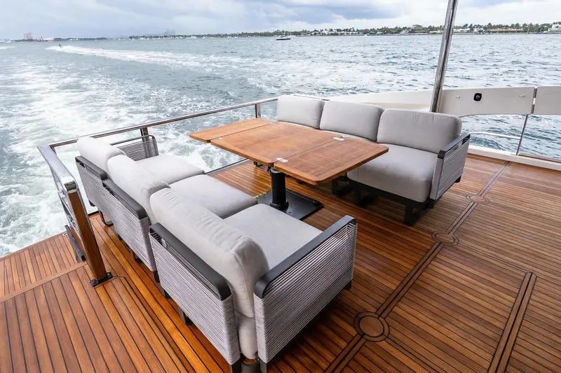 Slide: The Image of Luxurious deck of 2026 Absolute NAVETTA 70 yacht with elegant seating and ocean view. - 12