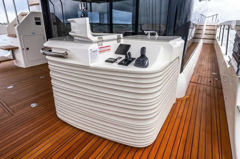 Slide: The Image of Luxurious 2026 Absolute NAVETTA 70 yacht deck with modern seating and ocean view. - 16
