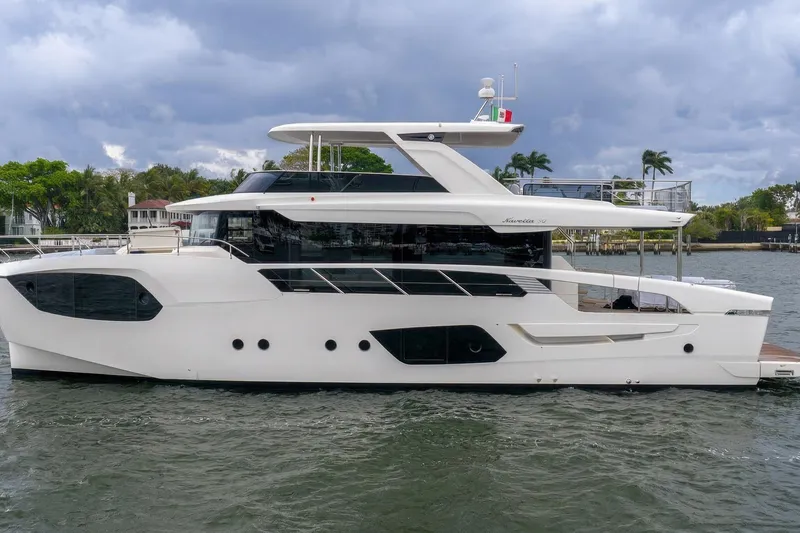 The Image of Luxury Absolute NAVETTA 70 yacht, 2026 model, cruising on a scenic waterway. - 2
