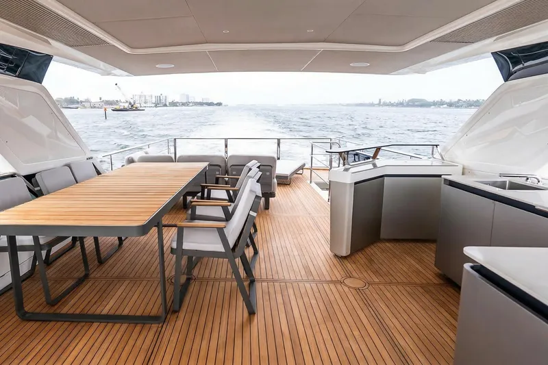 Slide: The Image of Luxurious 2026 Absolute NAVETTA 70 yacht deck with elegant dining area and scenic waterfront view. - 21