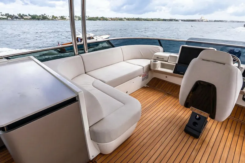 Slide: The Image of Luxurious seating area on the 2026 Absolute NAVETTA 70 yacht with wooden table. - 25