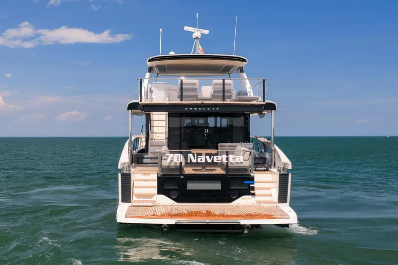 Slide: The Image of Luxury yacht Absolute Navetta 70, 2027 model, cruising on open sea under clear blue sky. - 3