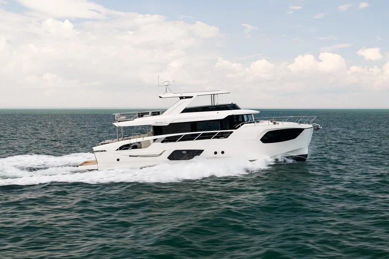 Slide: The Image of Luxurious 2027 Absolute Navetta 70 yacht cruising on open sea under clear skies. - 4