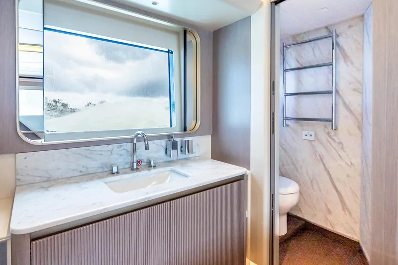 Slide: The Image of Luxurious interior of Absolute NAVETTA 70 yacht, featuring a modern wine cooler, 2026 model. - 70