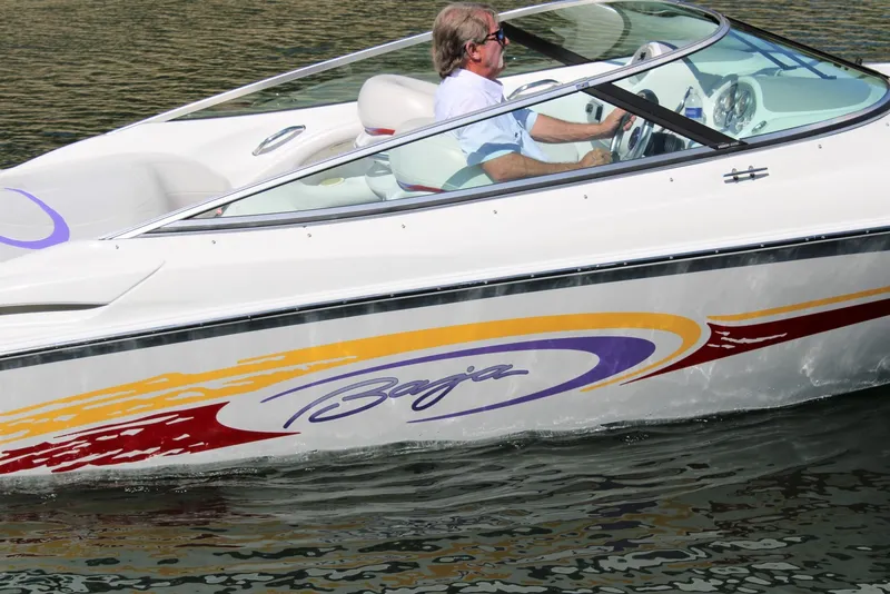 Slide: The Image of 2002 Baja 232 speedboat with colorful graphics on water. - 12