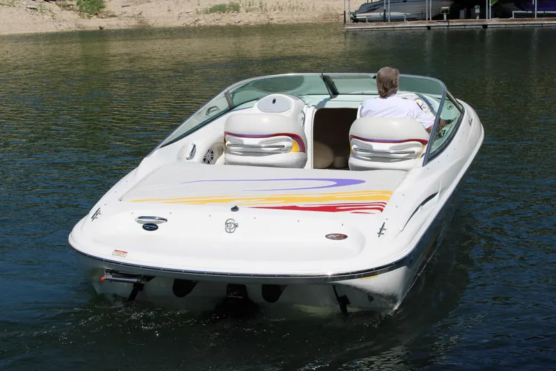 Slide: The Image of 2002 Baja 232 speedboat on water, featuring colorful graphics and sleek design. - 13