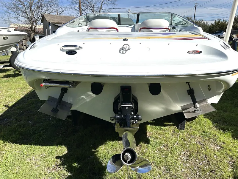 Slide: The Image of 2002 Baja 232 boat rear view with propeller, parked on grass. - 21