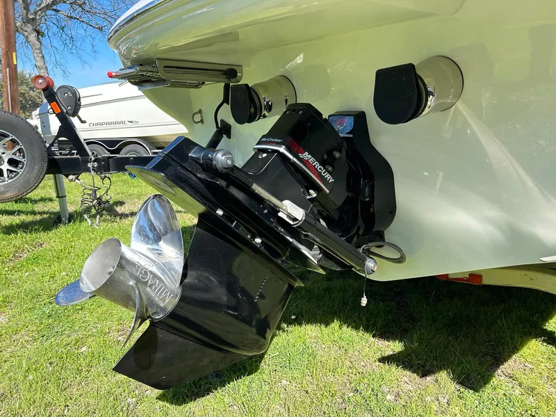 Slide: The Image of 2002 Baja 232 boat with Mercury outboard motor and propeller on grassy area. - 22