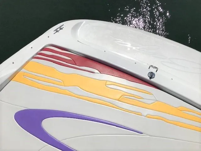 Slide: The Image of 2002 Baja 232 boat with colorful abstract design on deck, featuring red, yellow, and purple accents. - 25