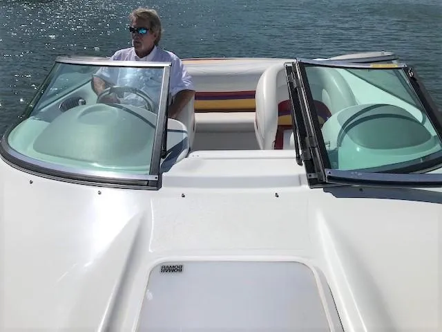 Slide: The Image of 2002 Baja 232 speedboat on water with driver, featuring sleek design and open cockpit. - 28