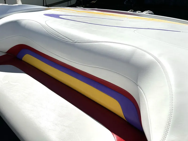 Slide: The Image of 2002 Baja 232 boat interior with colorful, sleek upholstery design. - 34