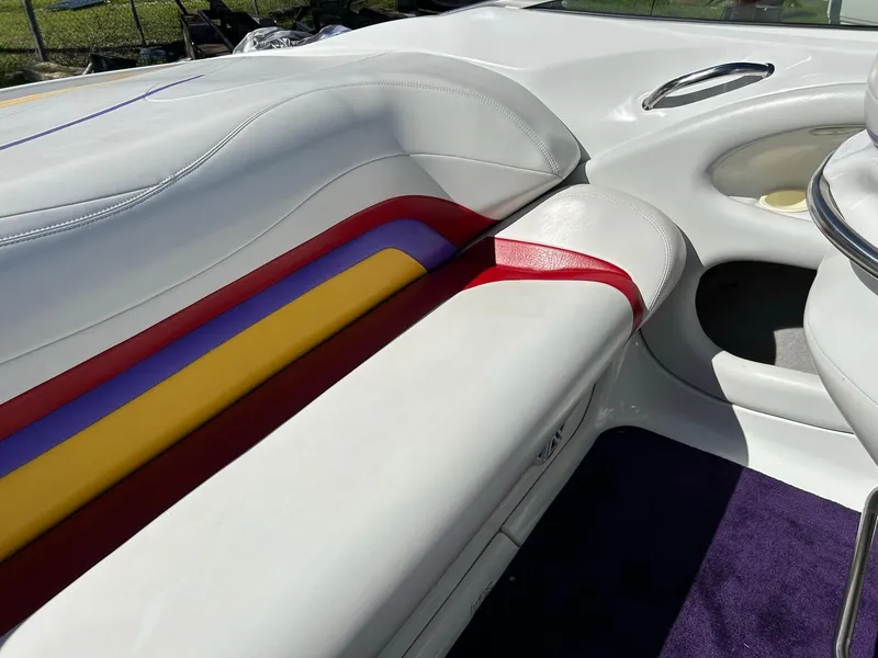 Slide: The Image of Interior of a 2002 Baja 232 boat with colorful seating and sleek design. - 35