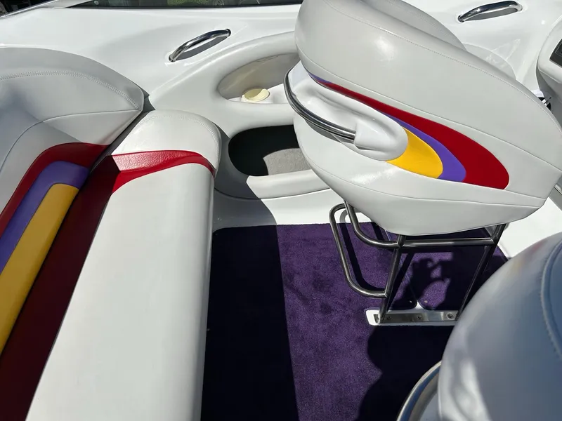 Slide: The Image of 2002 Baja 232 boat interior with colorful upholstery and sleek design. - 36