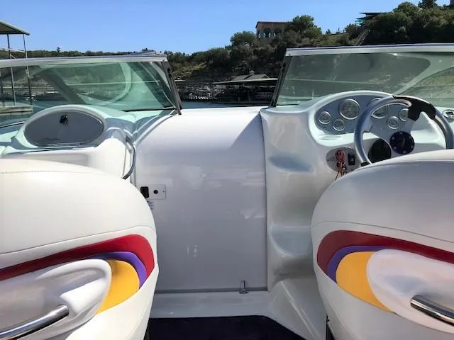 Slide: The Image of 2002 Baja 232 boat interior with colorful seats and steering wheel. - 41