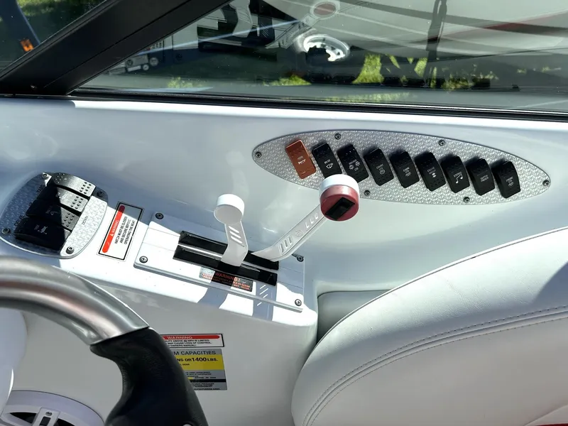 Slide: The Image of Interior controls of a 2002 Baja 232 boat, featuring throttle and switch panel. - 46