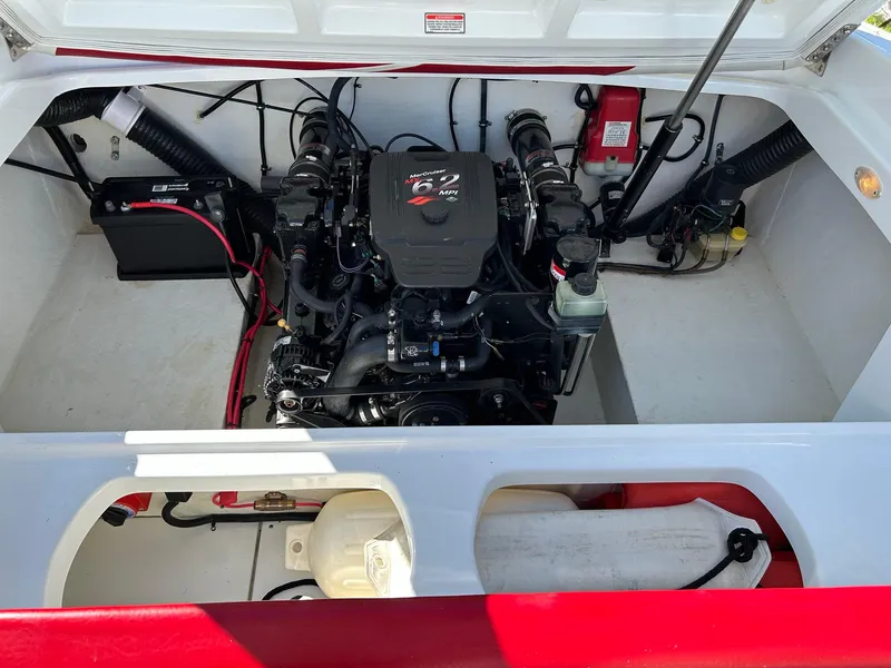Slide: The Image of Engine compartment of a 2002 Baja 232 boat, featuring a MerCruiser 6.2 MPI engine. - 48