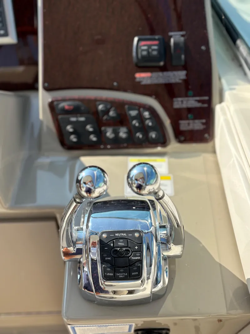 Slide: The Image of Control panel of a 2012 Sea Ray 350 Sundancer boat with throttle levers. - 10