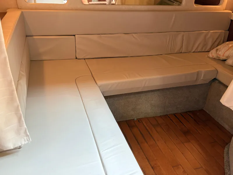 Slide: The Image of Interior seating area of a 2012 Sea Ray 350 Sundancer yacht with beige cushions. - 15