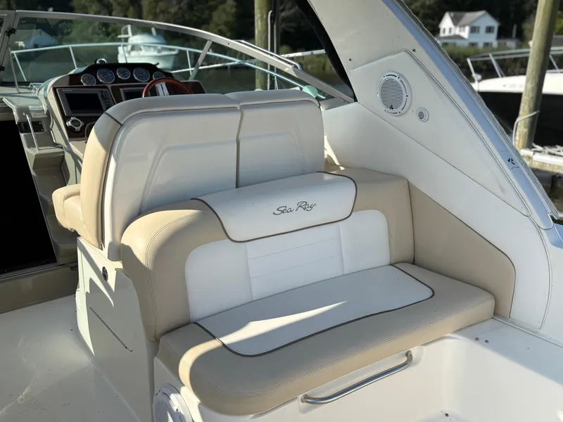 Slide: The Image of 2012 Sea Ray 350 Sundancer boat interior with beige and white seating. - 7