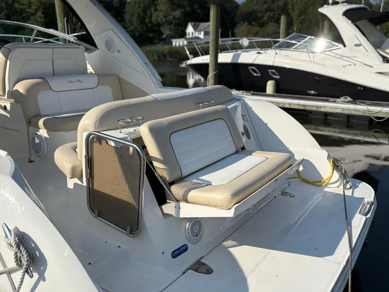 Slide: The Image of 2012 Sea Ray 350 Sundancer boat with beige seating at a marina. - 8