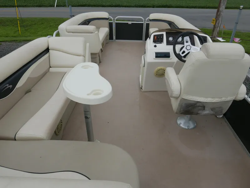 Slide: The Image of 2013 Bennington 22SLX pontoon boat interior with beige seating and steering console. - 11