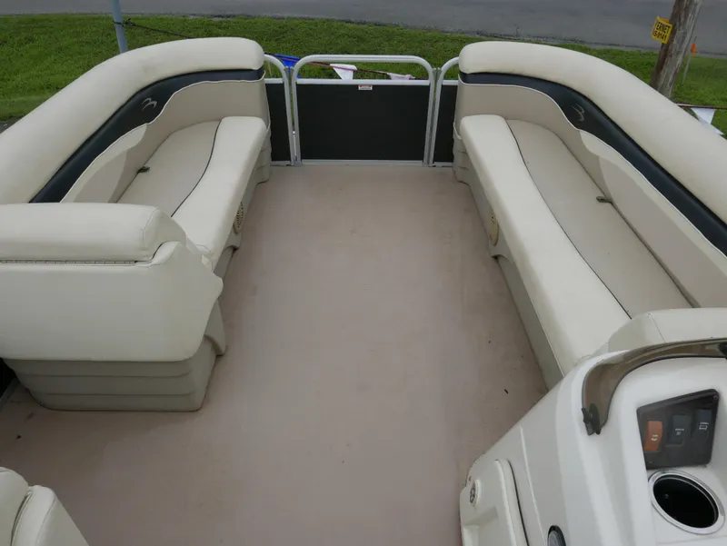 Slide: The Image of 2013 Bennington 22SLX pontoon boat interior with beige seating and spacious layout. - 4