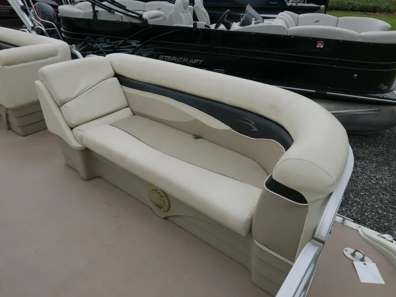 Slide: The Image of 2013 Bennington 22SLX boat interior with beige seating and black accents. - 5