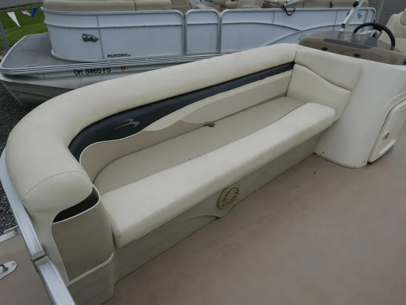Slide: The Image of 2013 Bennington 22SLX boat interior with beige seating and steering console. - 6