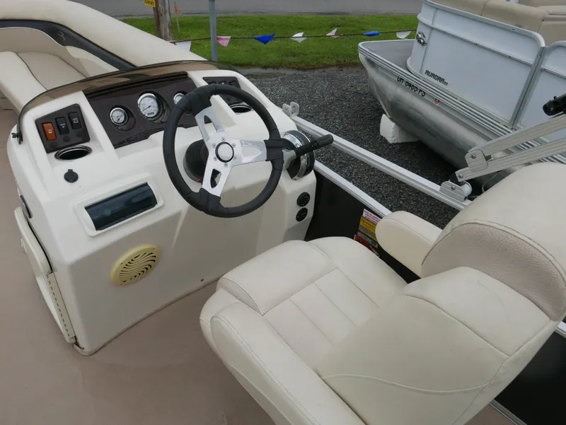 Slide: The Image of 2013 Bennington 22SLX boat interior with steering wheel and control panel. - 7