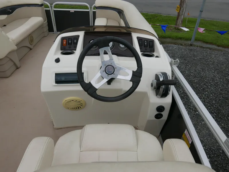 Slide: The Image of 2013 Bennington 22SLX boat helm with steering wheel and control panel. - 8