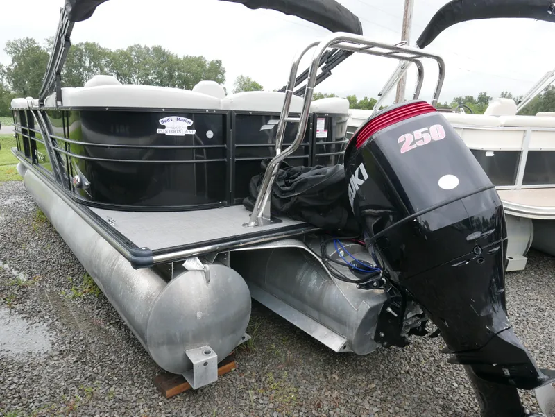 Slide: The Image of 2017 Starcraft SLS3 pontoon boat with Suzuki 250 outboard motor, parked on gravel. - 3