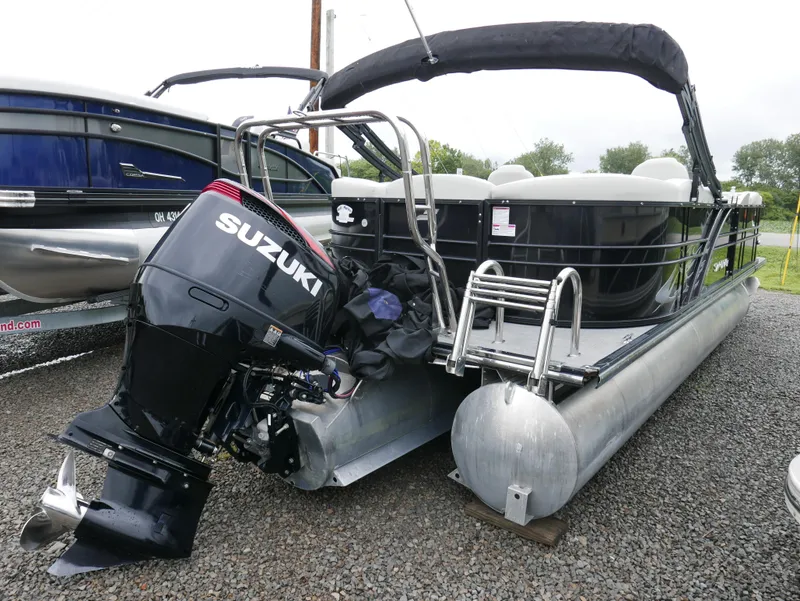 Slide: The Image of 2017 Starcraft SLS3 pontoon boat with Suzuki outboard motor on gravel. - 4