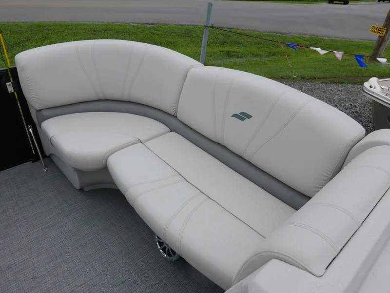 Slide: The Image of 2017 Starcraft SLS3 boat seating with gray upholstery, set against a grassy background. - 6