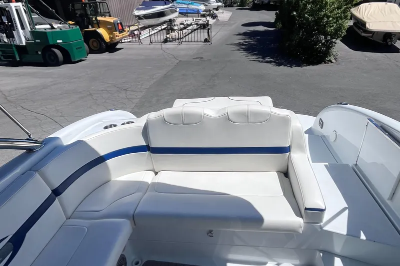 Slide: The Image of 2008 Formula 310 Bowrider boat with white and blue seating in a marina. - 11