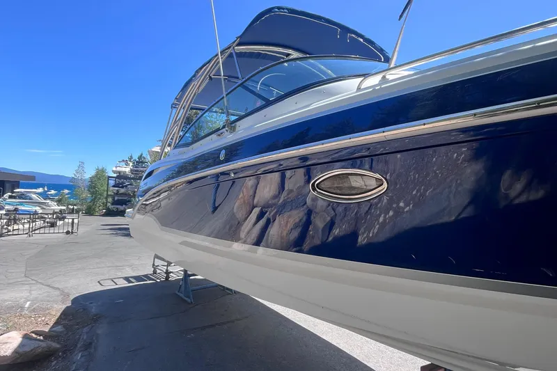 Slide: The Image of 2008 Formula 310 Bowrider boat on a stand, with a scenic marina background. - 3