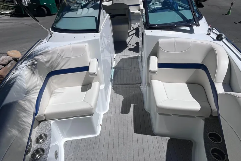 Slide: The Image of 2008 Formula 310 Bowrider interior with white and blue seating, cup holders, and windshield. - 8