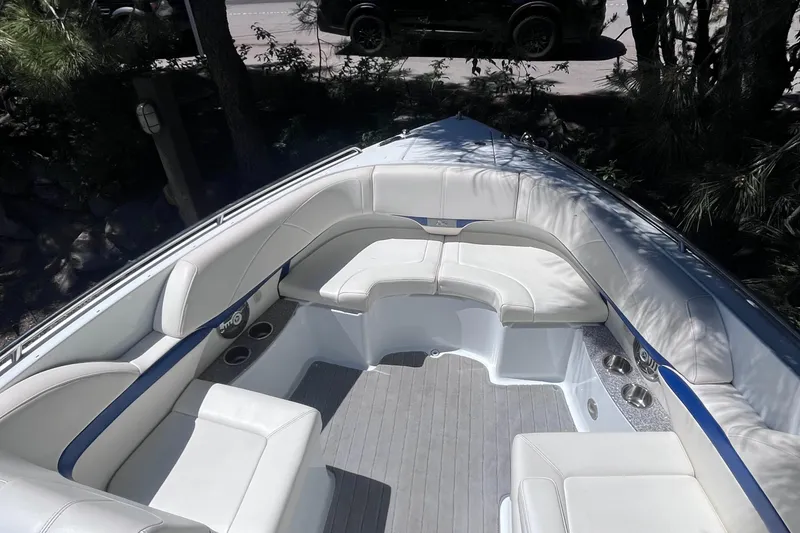 Slide: The Image of 2008 Formula 310 Bowrider boat interior with white seating and cup holders. - 9