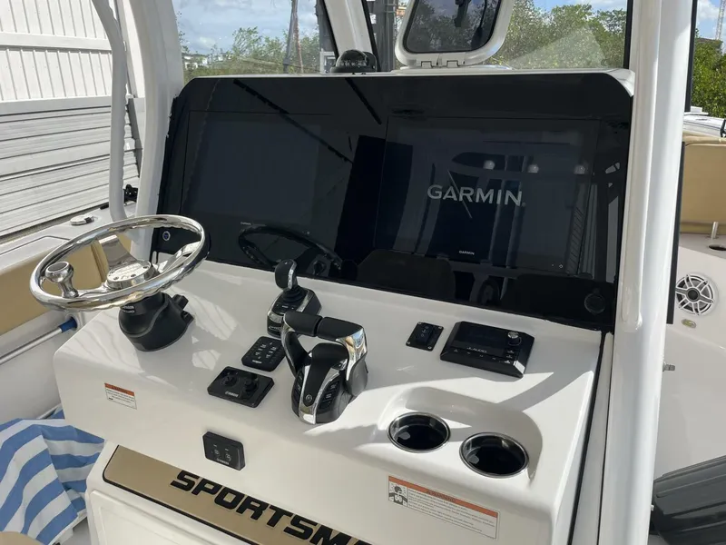 Slide: The Image of 2021 Sportsman 302 OPEN boat dashboard with Garmin display and steering wheel. - 10