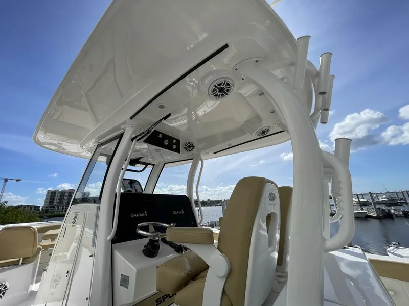 Slide: The Image of 2021 Sportsman 302 OPEN boat interior with helm, seats, and electronics under a clear sky. - 21