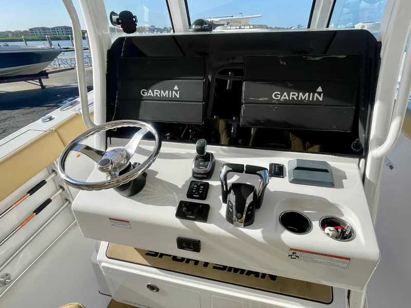 Slide: The Image of Cockpit of 2021 Sportsman 302 OPEN boat with Garmin navigation displays and steering wheel. - 27