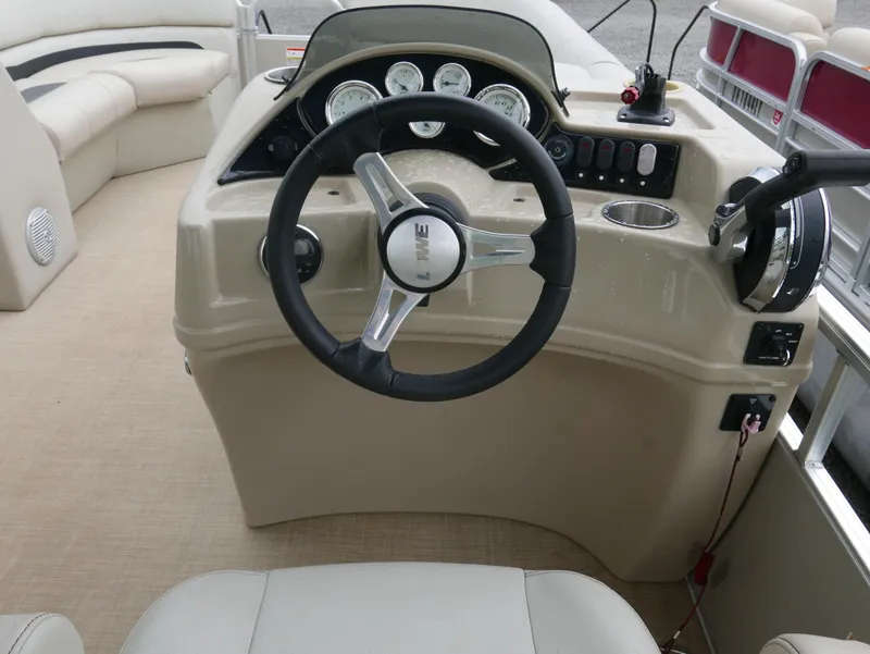 Slide: The Image of Steering console of a 2015 Lowe SS230 boat with gauges and controls. - 11