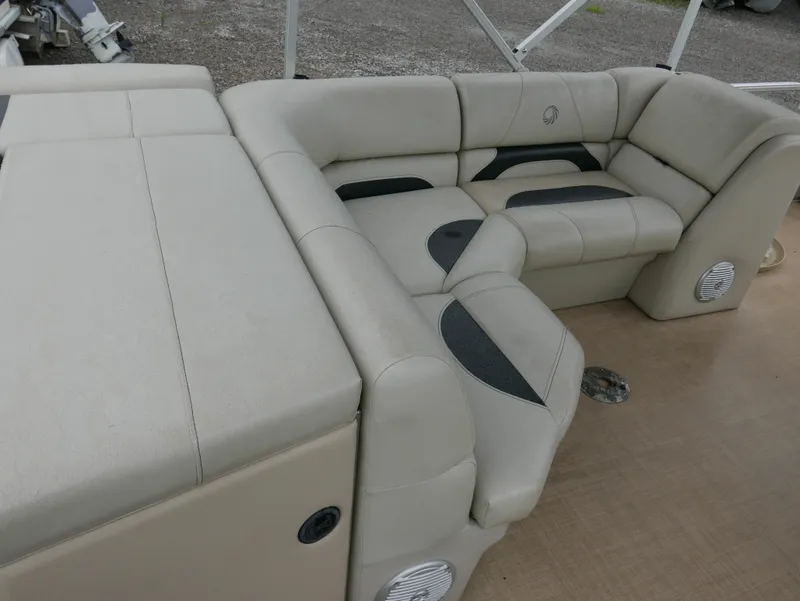 Slide: The Image of 2015 Lowe SS230 boat interior with beige cushioned seating and integrated speakers. - 12