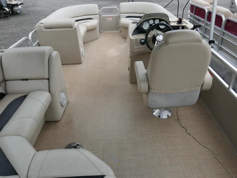 Slide: The Image of 2015 Lowe SS230 pontoon boat interior with beige seating and steering console. - 13