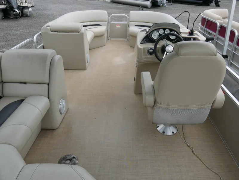 Slide: The Image of 2015 Lowe SS230 pontoon boat interior with beige seating and steering console. - 14