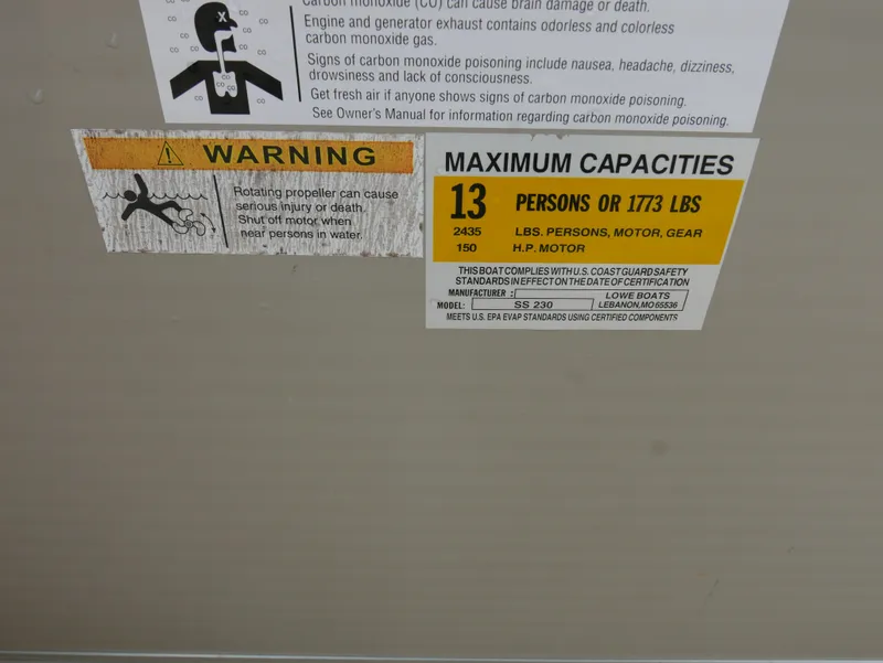 Slide: The Image of Warning and capacity labels on a 2015 Lowe SS230 boat. - 15