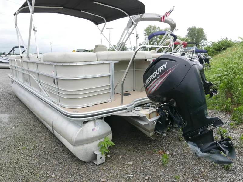 Slide: The Image of 2015 Lowe SS230 pontoon boat with Mercury outboard motor on gravel. - 16