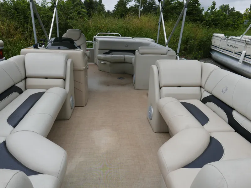 Slide: The Image of 2015 Lowe SS230 pontoon boat interior with beige seating and spacious layout. - 5